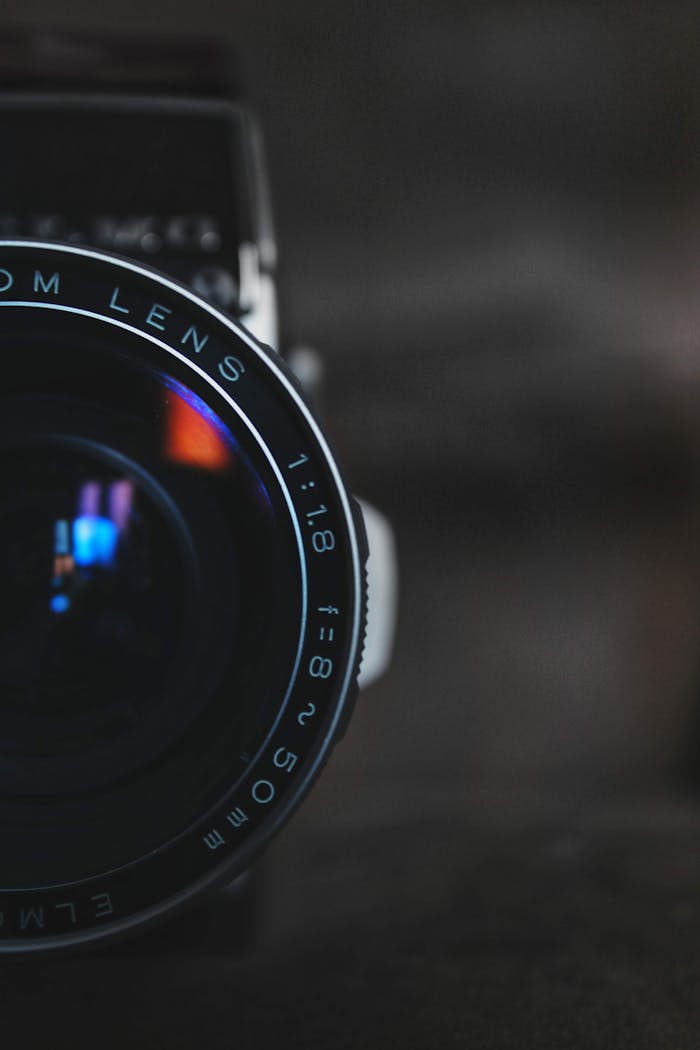 The Art of Drawing Readers In: Your attractive post title goes here Detailed close-up of a vintage camera lens capturing intricate reflections in a dark setting.